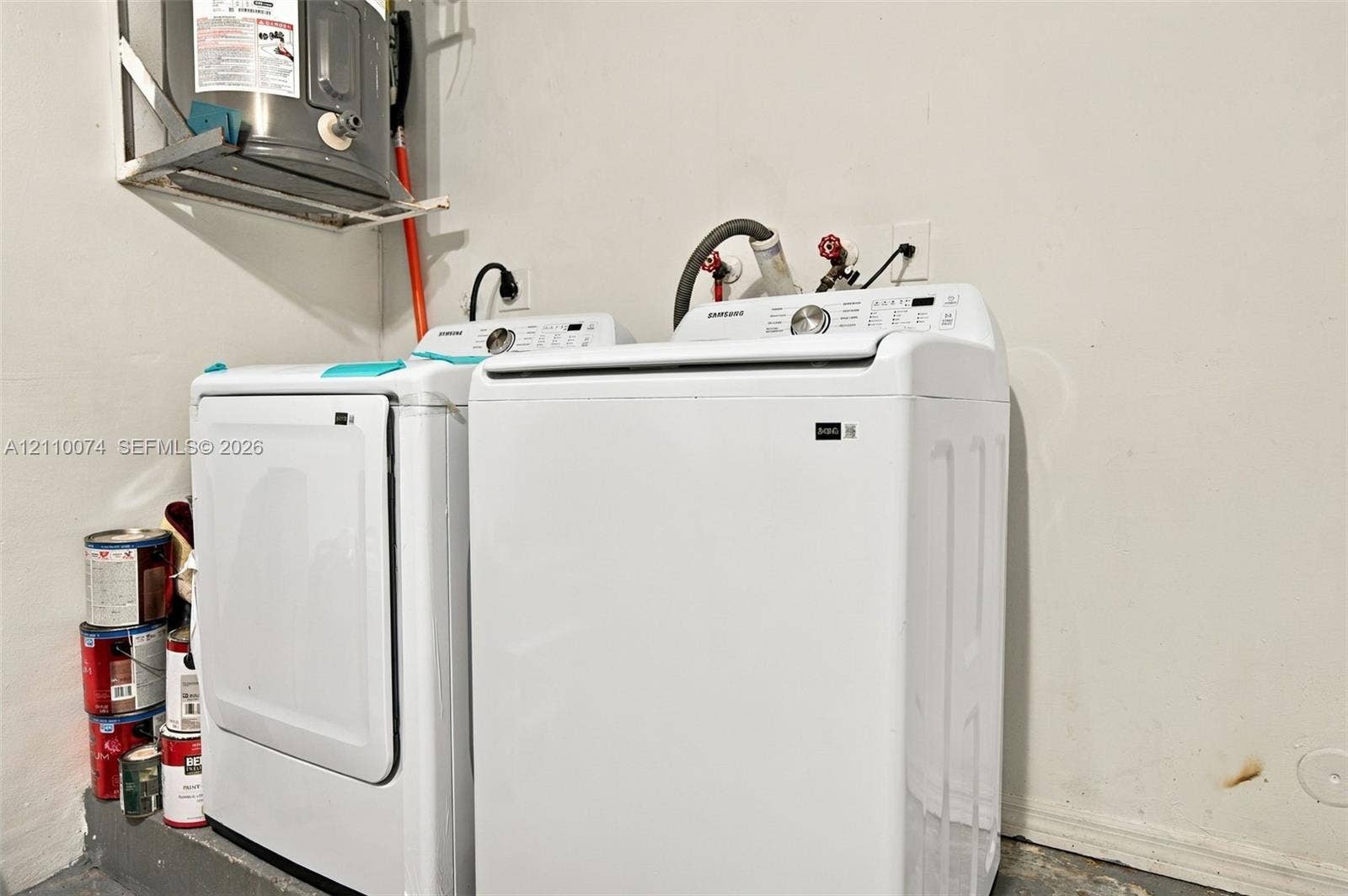 17370 NW 69th Court, #304, Hialeah, FL 33015 Laundry area featuring a wall-mounted water heater and dedicated appliance hookups