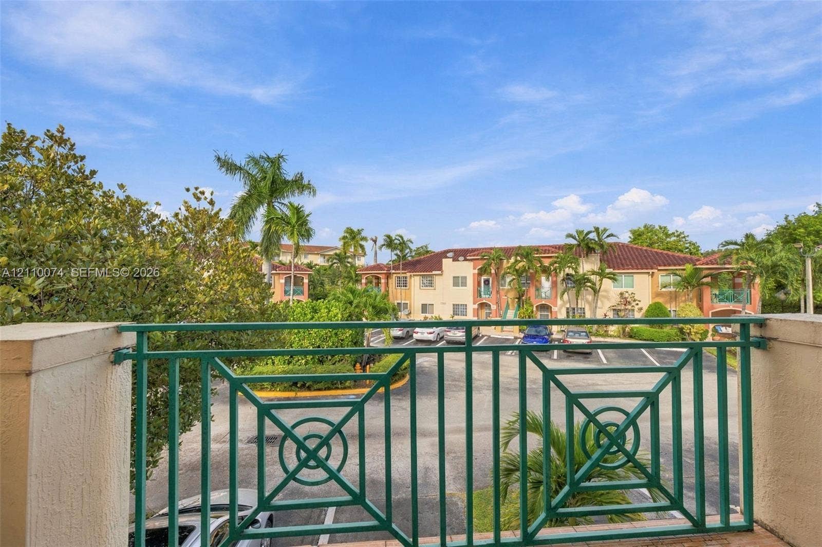 17370 NW 69th Court, #304, Hialeah, FL 33015 Balcony featuring green metal railing, stucco pillars, and tile flooring