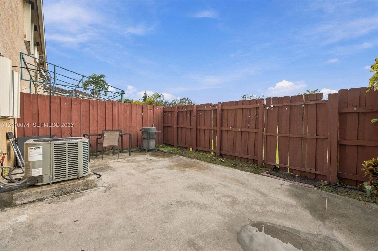 17370 NW 69th Court, #304, Hialeah, FL 33015 Rear concrete patio enclosed by a perimeter wood-slat fence