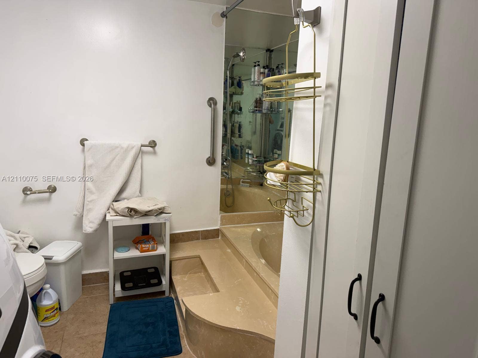 2017 S Ocean Drive, #208, Hallandale Beach, Hallandale Beach, FL 33009 Full-height built-in cabinetry with matte black hardware, sunken soaking tub with integrated surround, floor-to-ceiling mirror, and wall-mounted support bars