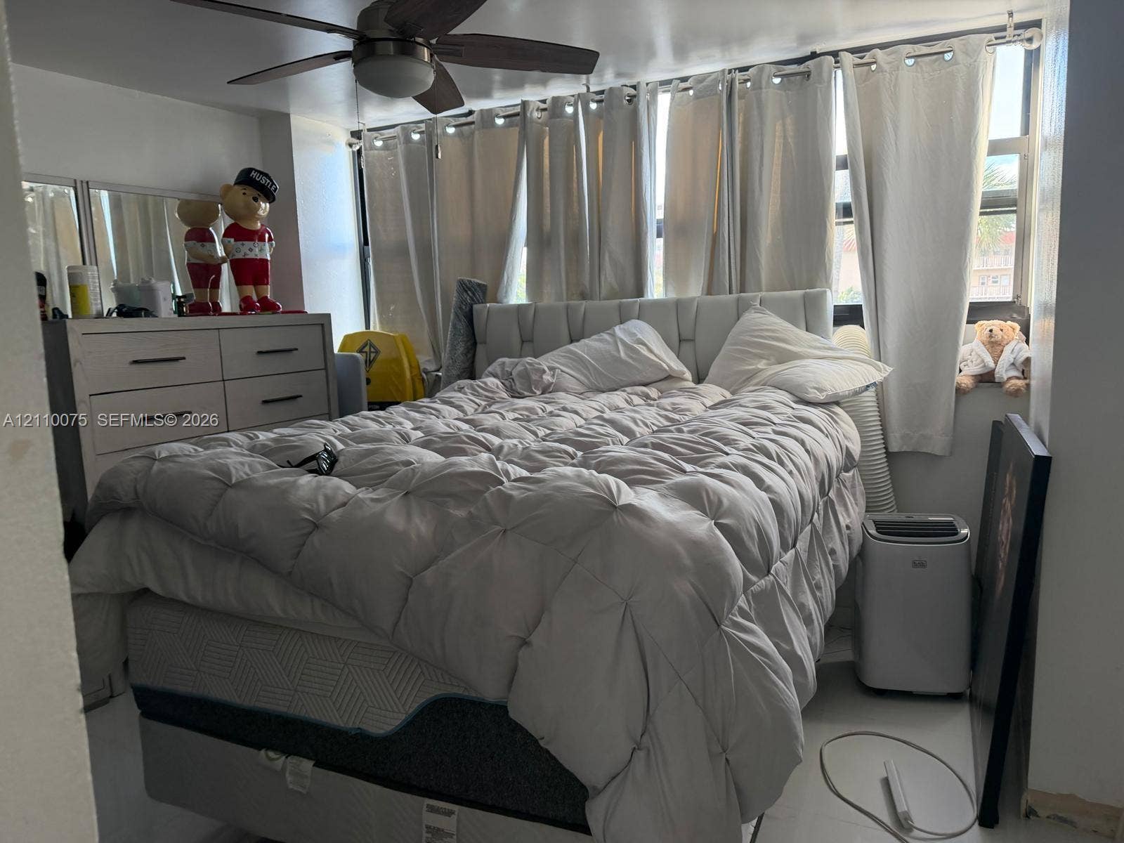 2017 S Ocean Drive, #208, Hallandale Beach, Hallandale Beach, FL 33009 Floor-to-ceiling windows with expansive glass, neutral wall finishes, and a modern ceiling fan