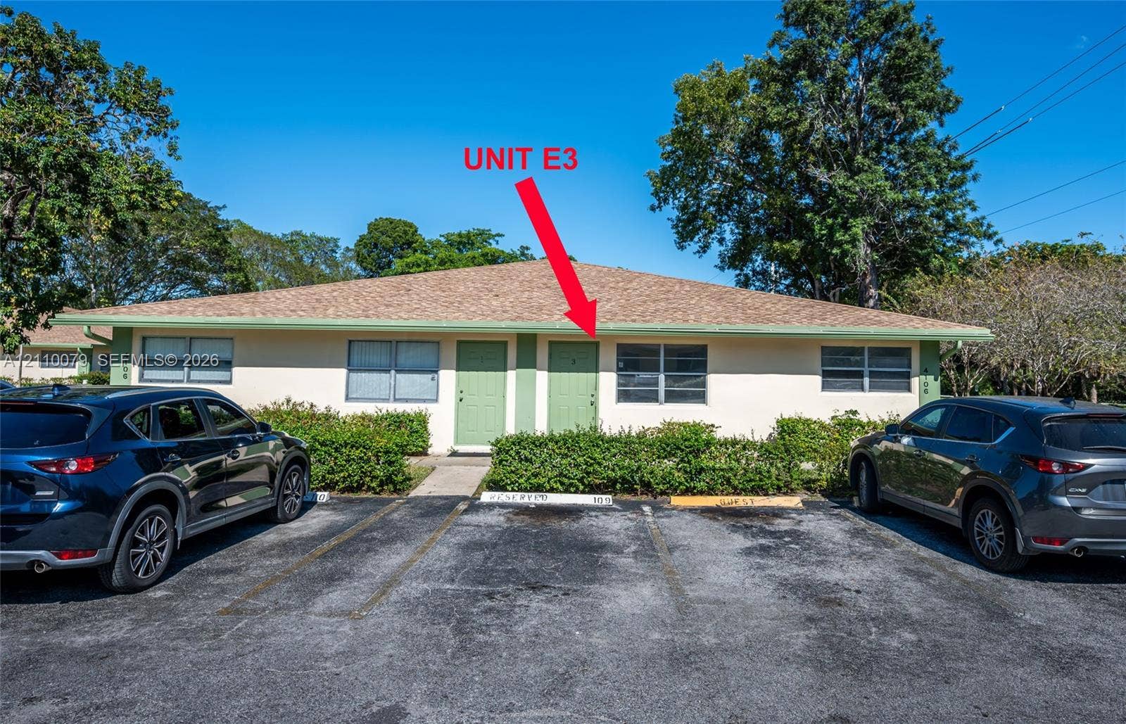 4106 NW 88th Avenue, #3, Coral Springs, FL 33065 Single-story residence featuring a shingle roof, exterior light-colored stucco, and designated asphalt parking