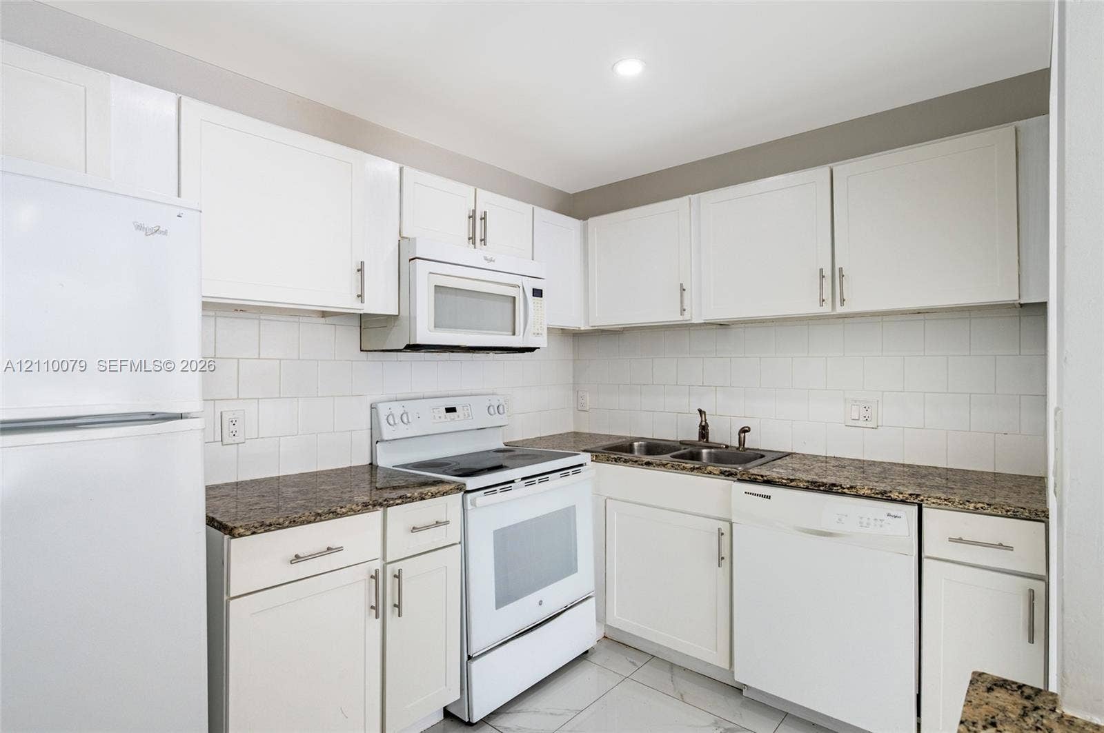 4106 NW 88th Avenue, #3, Coral Springs, FL 33065 Kitchen featuring white cabinetry, stone-finish countertops, subway tile backsplash, white appliances, and tiled flooring