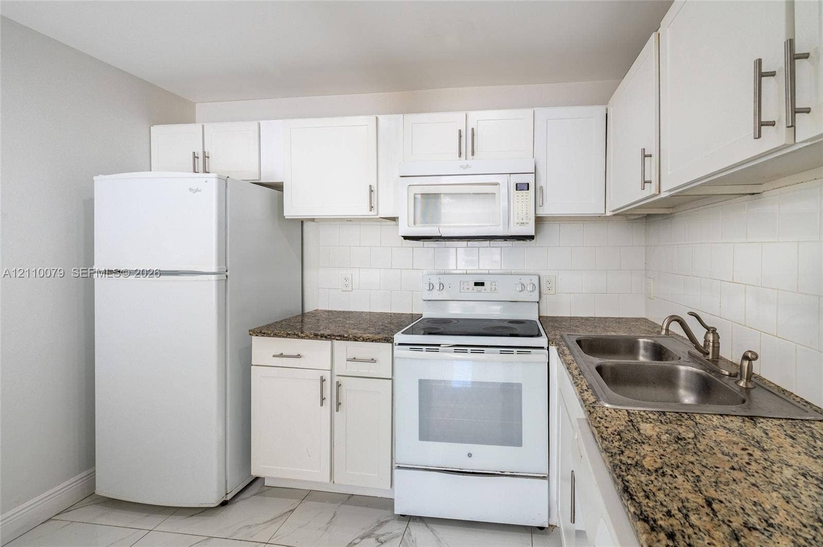 4106 NW 88th Avenue, #3, Coral Springs, FL 33065 Kitchen featuring white cabinetry, stone-finish countertops, subway tile backsplash, white appliances, and a dual-basin stainless steel sink