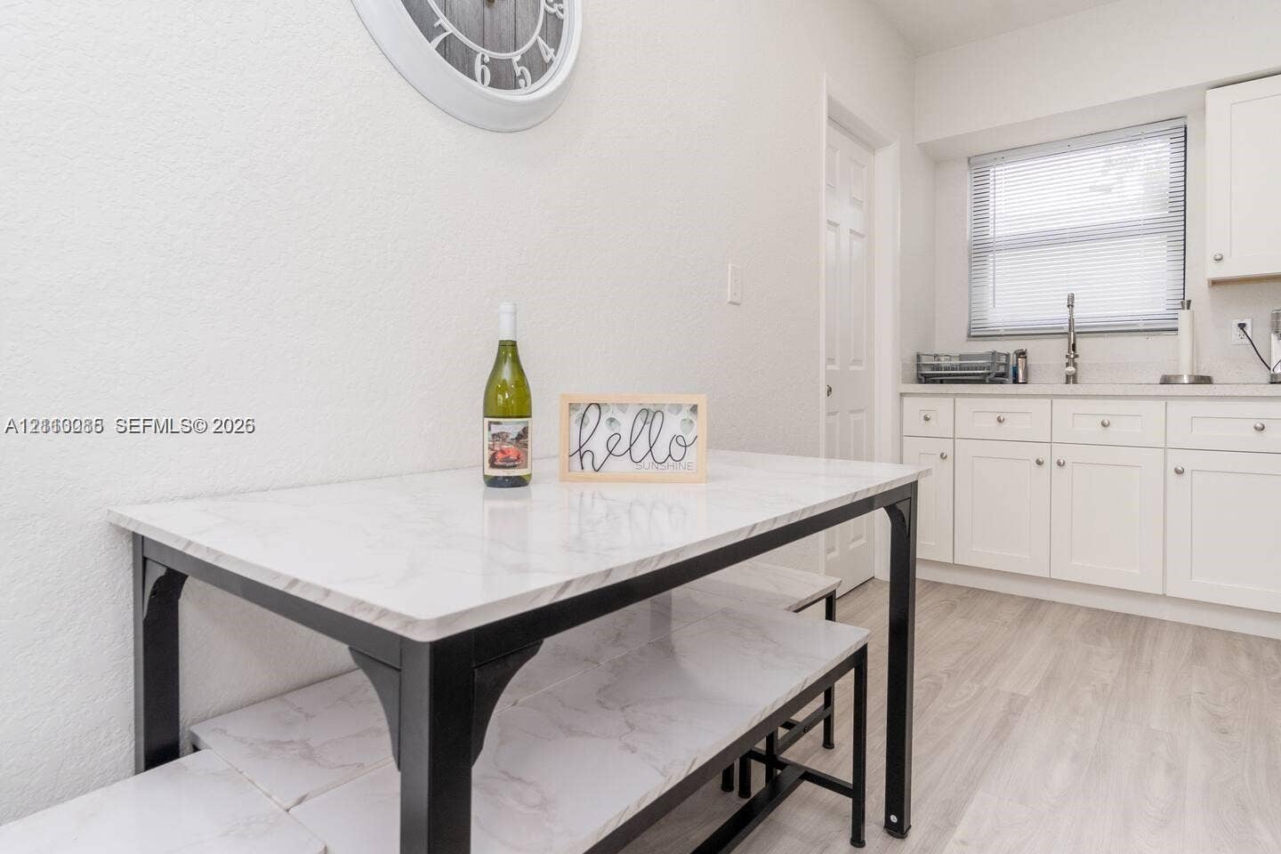 7815 NW 5th Court, #1, Miami, Miami, FL 33150 White Shaker-style cabinetry, solid-surface countertops, stainless steel faucet, and light-toned wood-finish flooring