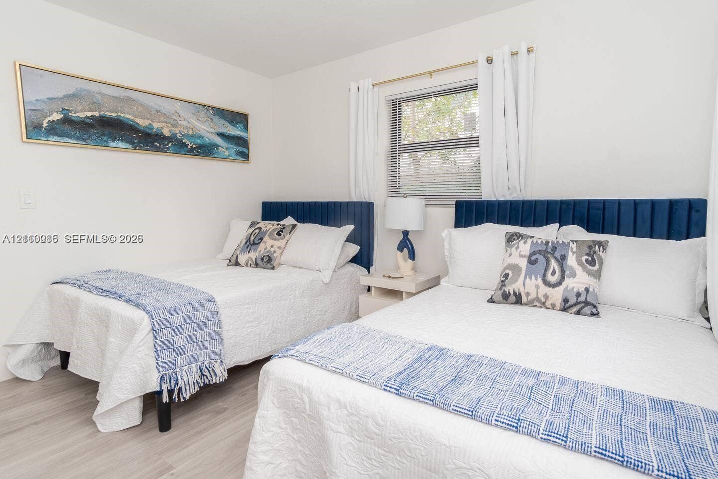 7815 NW 5th Court, #1, Miami, Miami, FL 33150 Neutral-toned room featuring wood-finish flooring and a window with horizontal blinds