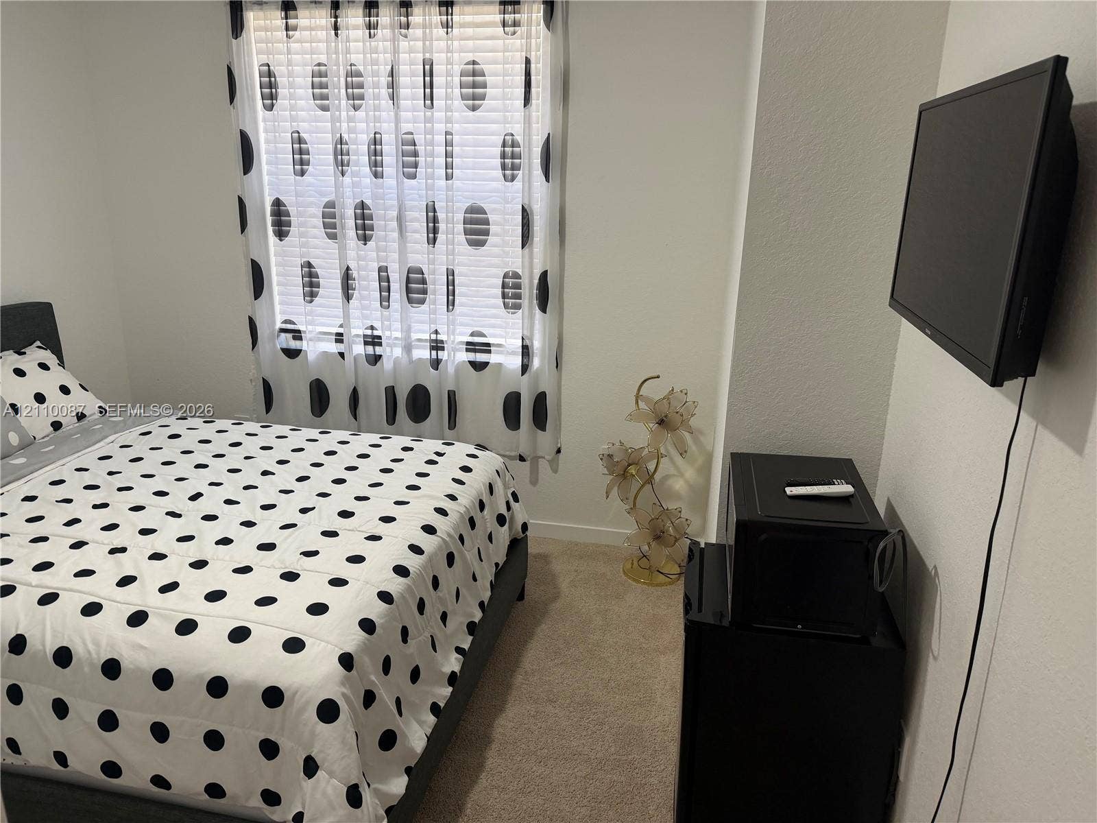 1358 NE 3rd Avenue, #1, Florida City, Florida City, FL 33034 Neutral-toned carpeted flooring, white wall finish, and a window with horizontal blinds