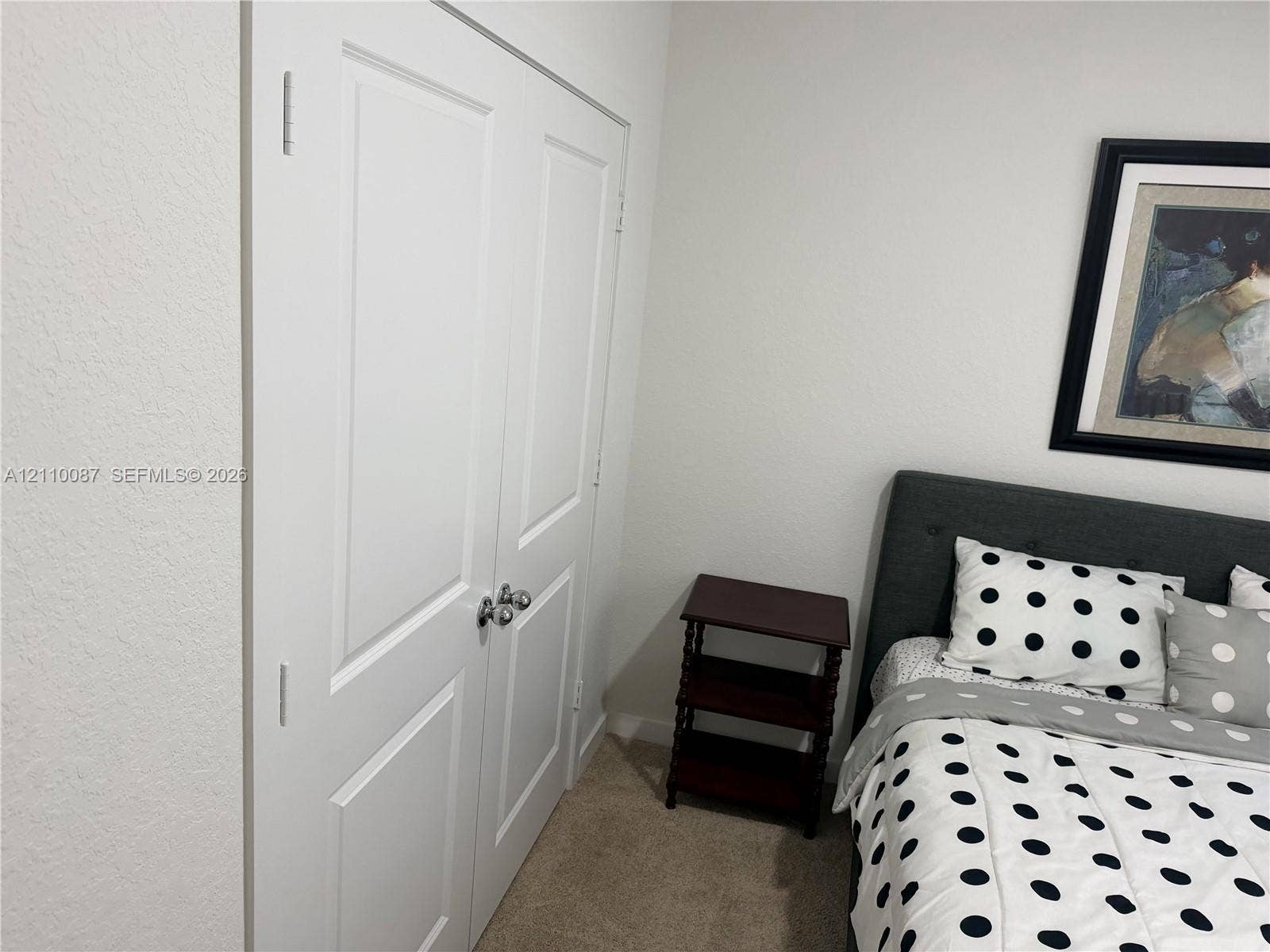 1358 NE 3rd Avenue, #1, Florida City, Florida City, FL 33034 White double-panel closet doors featuring chrome spherical knobs and neutral wall-to-wall carpeting