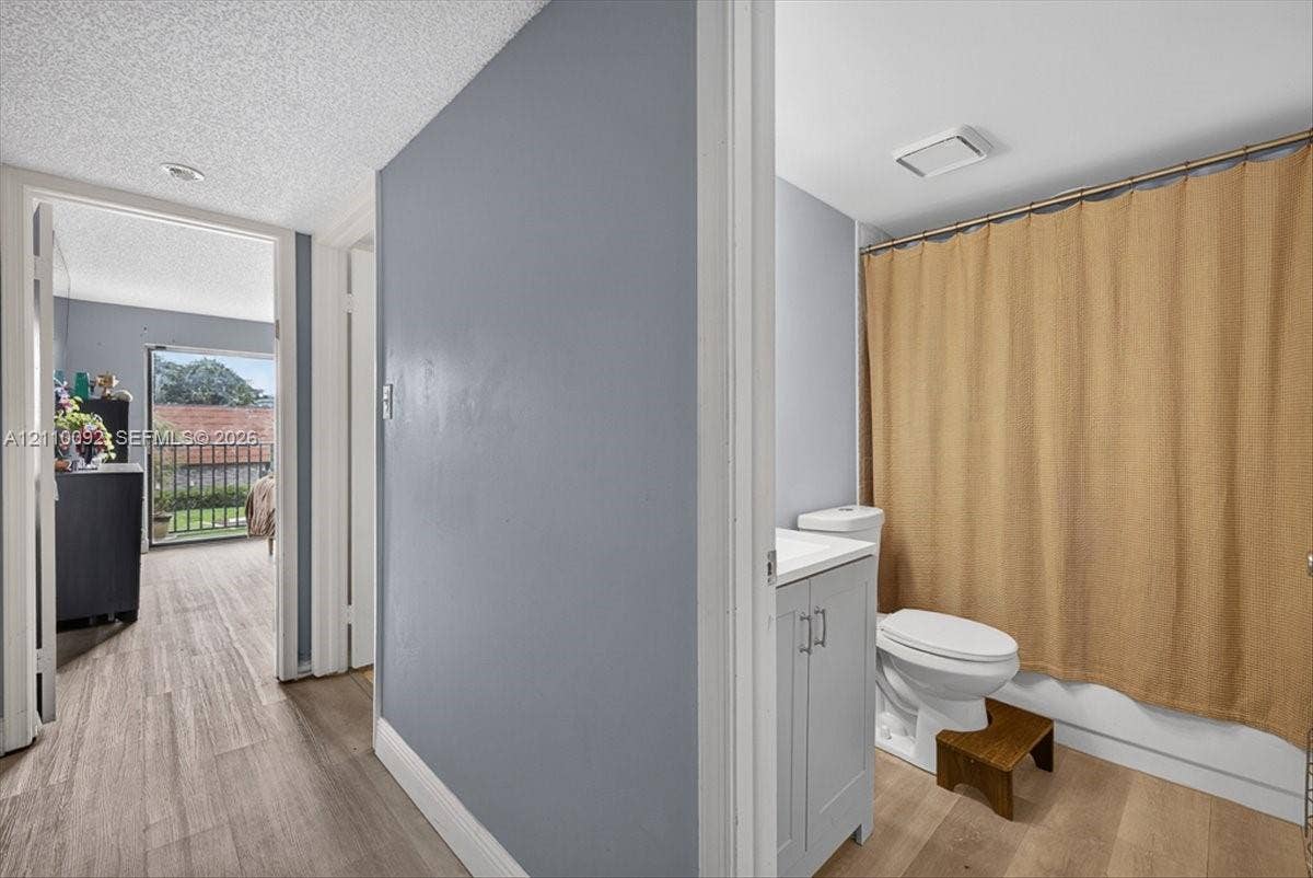 1403 SW 110th Way, Davie, FL 33324 Bathroom featuring a gray vanity cabinet, solid-surface countertop, and wood-finish flooring