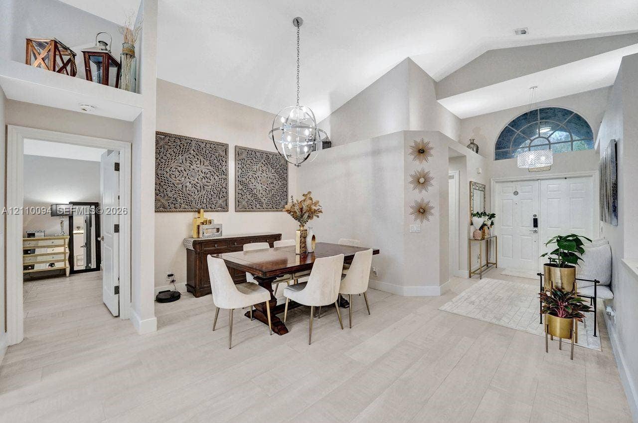 2064 Island Circle, Weston, FL 33326 Vaulted ceilings, wood-finish flooring, recessed architectural niche, spherical pendant lighting, and arched transom window