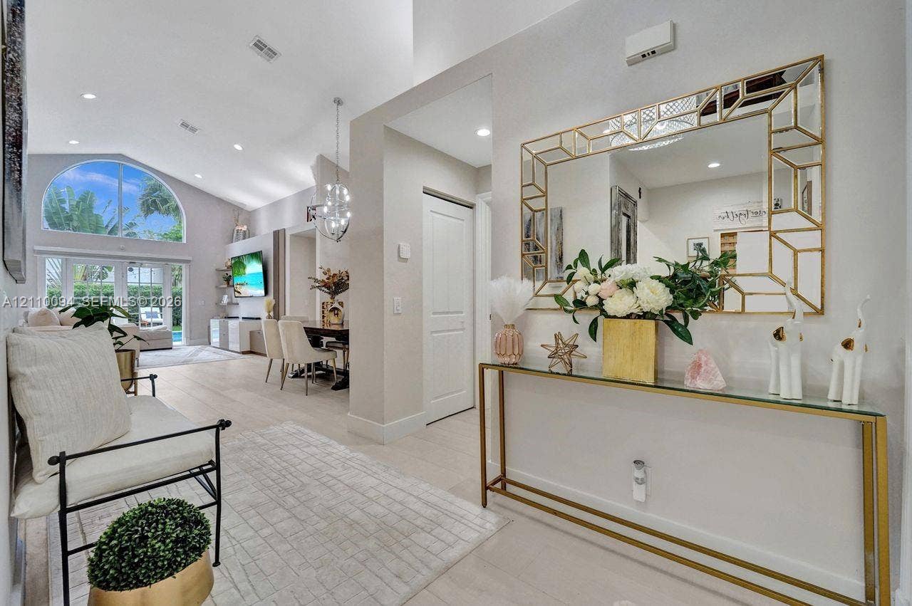 2064 Island Circle, Weston, FL 33326 Vaulted ceiling featuring recessed lighting and a large arched window with glass-paned double doors