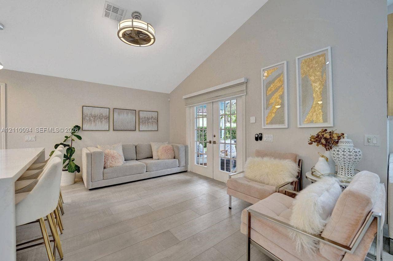 2064 Island Circle, Weston, FL 33326 Vaulted ceiling, wood-finish flooring, and glass-paneled double doors leading to the exterior