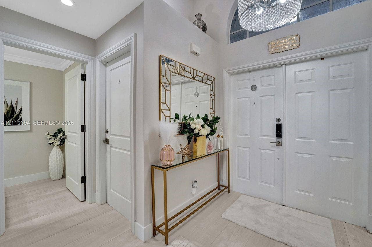 2064 Island Circle, Weston, FL 33326 Entryway featuring double-door entry, arched transom window, recessed lighting, chandelier, and light-toned wood-finish flooring