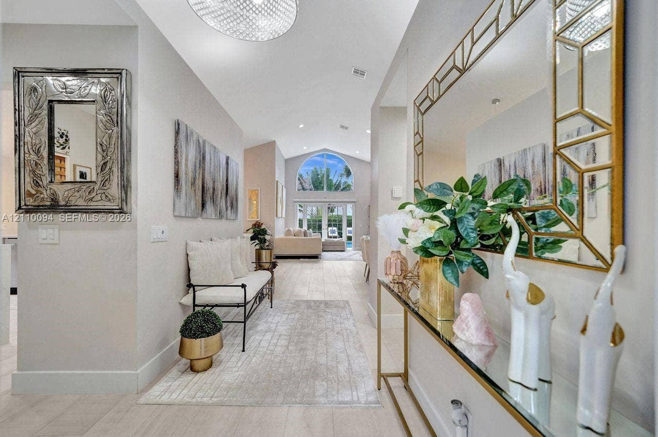 2064 Island Circle, Weston, FL 33326 Vaulted ceilings, large arched transom window, and light-toned wood-finish flooring