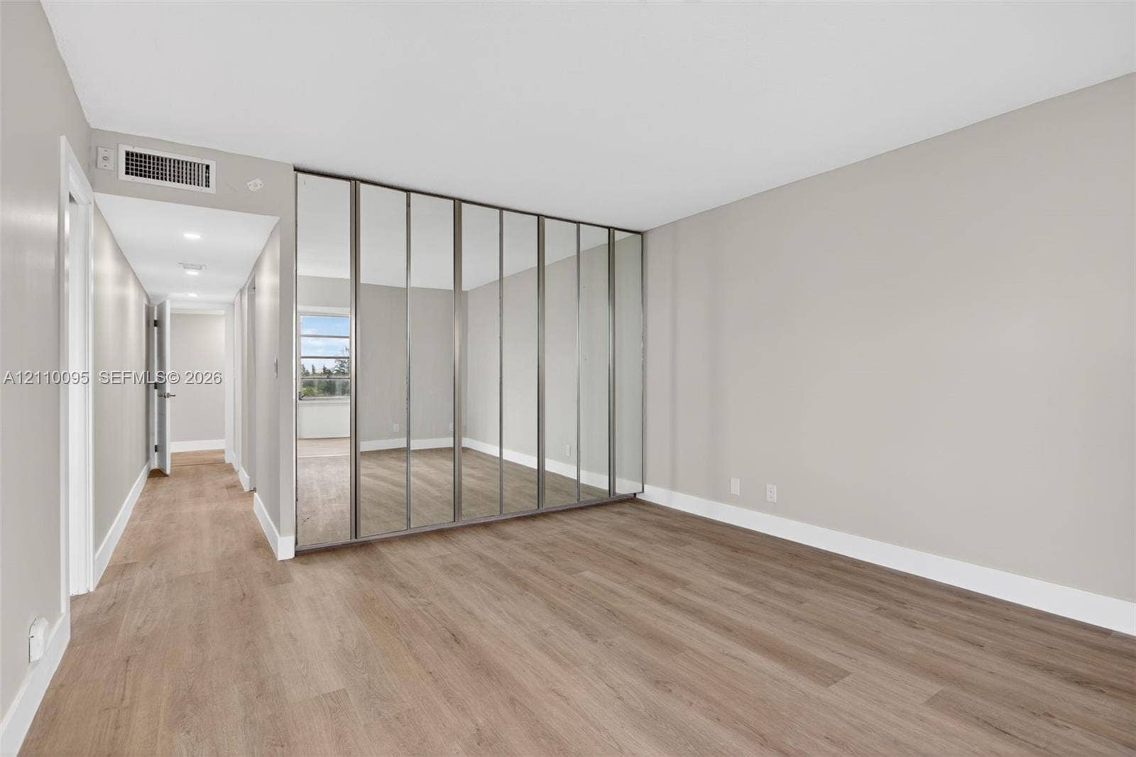 3090 N Course Drive, #807, Pompano Beach, Pompano Beach, FL 33069 Full-height mirrored closet doors, neutral wall palette, wood-finish flooring, and recessed ceiling lighting