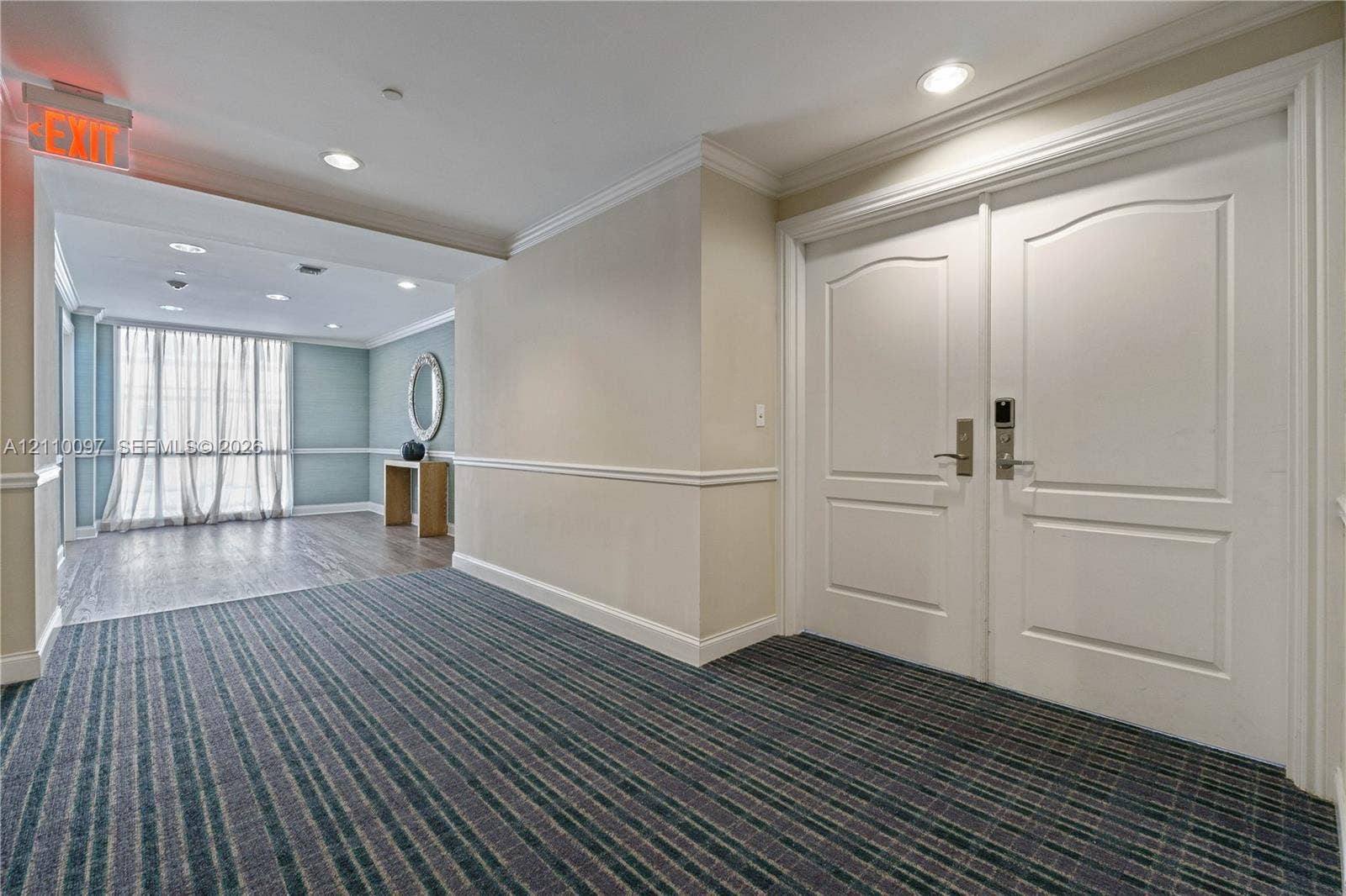 Double-door entry featuring paneled millwork, crown molding, and recessed lighting