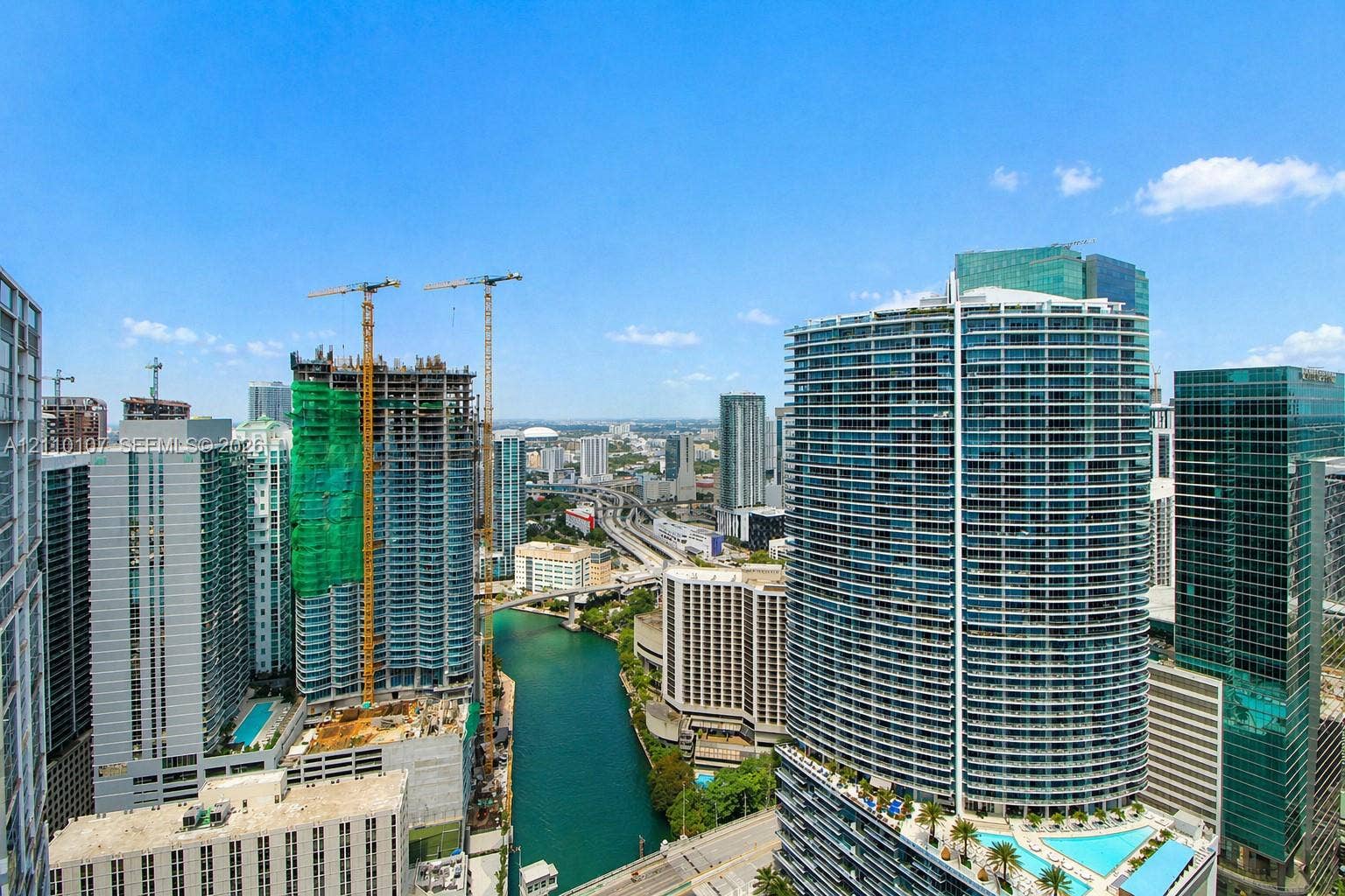465 Brickell Avenue, #4604, Miami, Miami, FL 33131 High-rise urban landscape featuring a waterway, multi-story glass-facade towers, and structured infrastructure