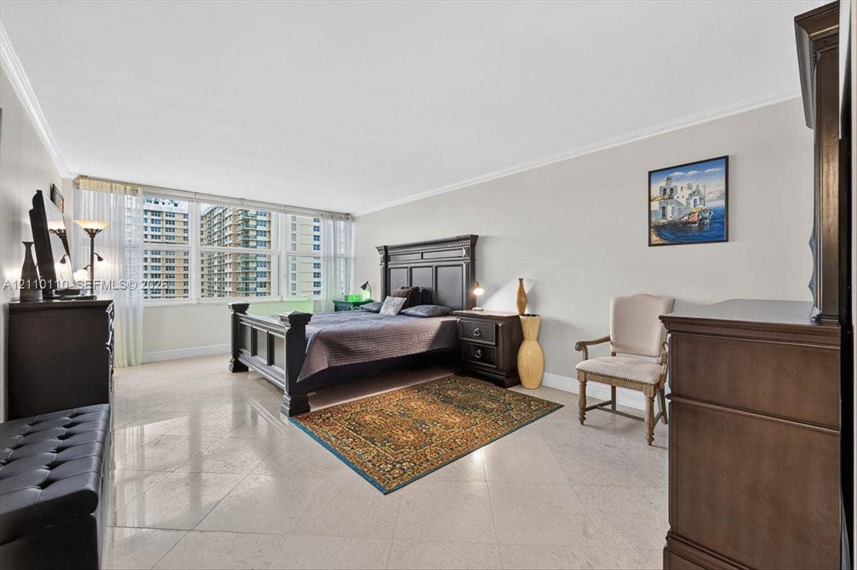 2751 S Ocean Drive, #801N, Hollywood, FL 33019 Spacious room featuring polished stone flooring, crown molding, and floor-to-ceiling windows