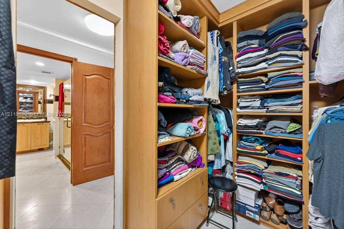 2751 S Ocean Drive, #801N, Hollywood, FL 33019 Custom floor-to-ceiling wooden built-in cabinetry featuring open shelving and integrated drawer storage