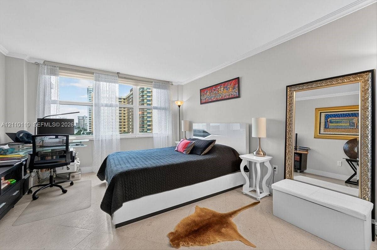 2751 S Ocean Drive, #801N, Hollywood, FL 33019 Room featuring large windows with multi-pane glazing, light-toned stone-finish flooring, and crown molding