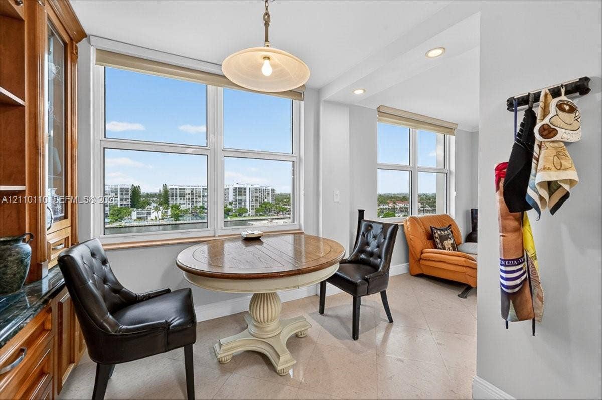 2751 S Ocean Drive, #801N, Hollywood, FL 33019 Built-in wood cabinetry, large multi-pane windows, recessed ceiling lighting, pendant light fixture, and stone-finish tile flooring
