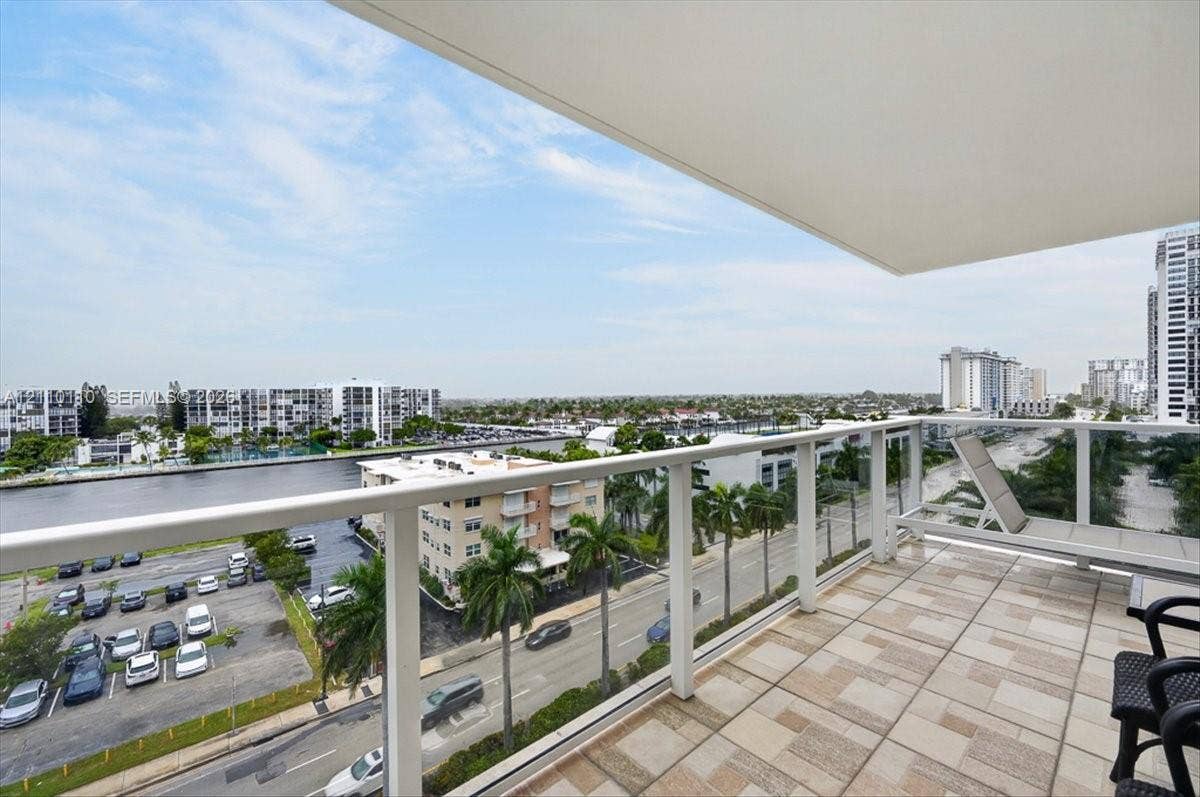 2751 S Ocean Drive, #801N, Hollywood, FL 33019 Private balcony featuring a geometric tile floor, white structural railings, and an overhead canopy