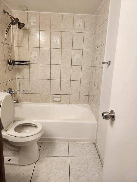 14185 SW 87th Street, #A110, Miami, FL 33183 Bathroom featuring a porcelain tub, wall-mounted shower head, ceramic wall tiling, and light-toned tile flooring