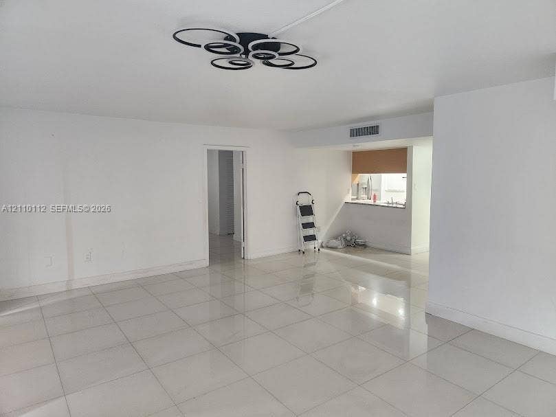 14185 SW 87th Street, #A110, Miami, FL 33183 Large-format tile flooring, modern circular LED flush-mount lighting, and pass-through counter area