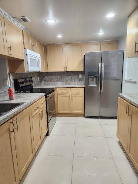 14185 SW 87th Street, #A110, Miami, FL 33183 Kitchen featuring light-finish cabinetry, stone-texture countertops, tile flooring, recessed ceiling lighting, and stainless steel appliances
