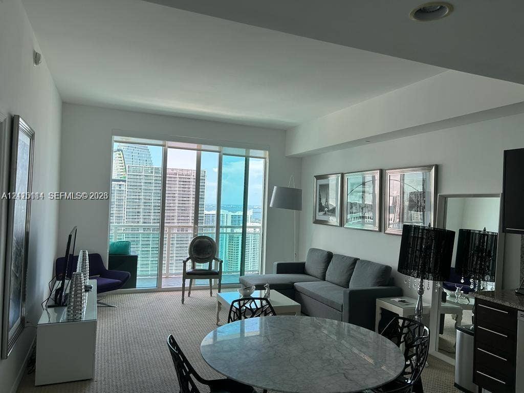 950 Brickell Bay Drive, #5108, Miami, Miami, FL 33131 Floor-to-ceiling sliding glass doors, recessed lighting, and wall-to-wall carpeting