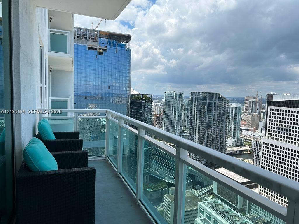 950 Brickell Bay Drive, #5108, Miami, Miami, FL 33131 Private balcony featuring a glass-panel railing and concrete flooring, overlooking an urban cityscape