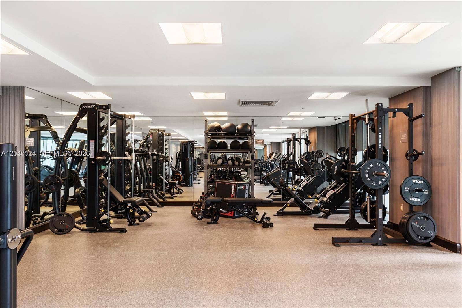950 Brickell Bay Drive, #5108, Miami, Miami, FL 33131 Fitness center featuring wall-to-wall mirrors, recessed lighting, and resilient composite flooring