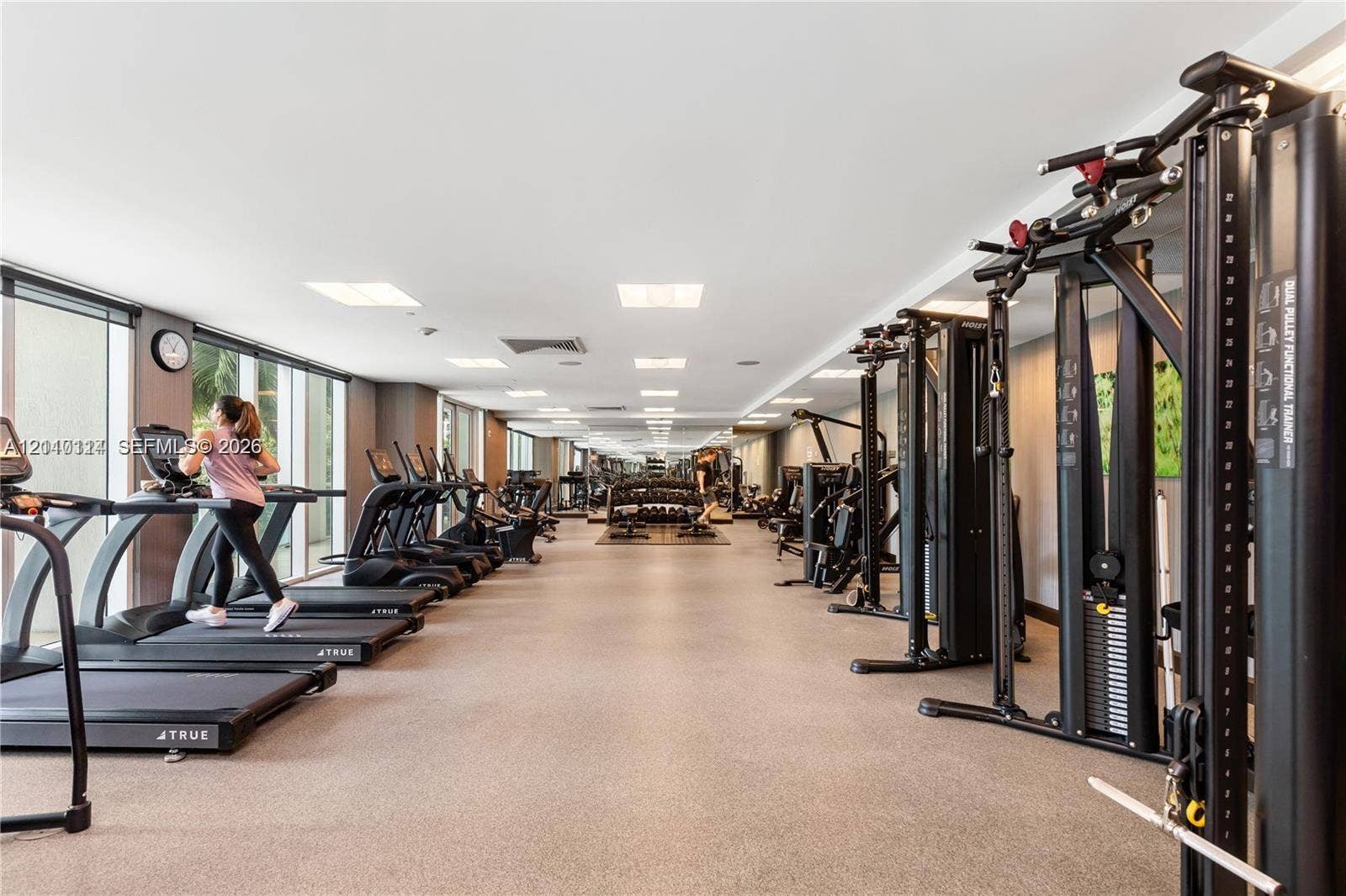 950 Brickell Bay Drive, #5108, Miami, Miami, FL 33131 Fitness center featuring expansive floor-to-ceiling windows, recessed lighting, rubberized flooring, and an array of professional-grade strength and cardiovascular equipment