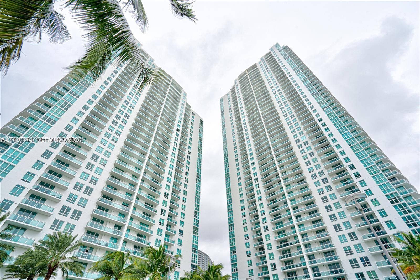 950 Brickell Bay Drive, #5108, Miami, Miami, FL 33131 High-rise residential towers featuring expansive floor-to-ceiling windows, uniform private balconies, and glass facade detailing