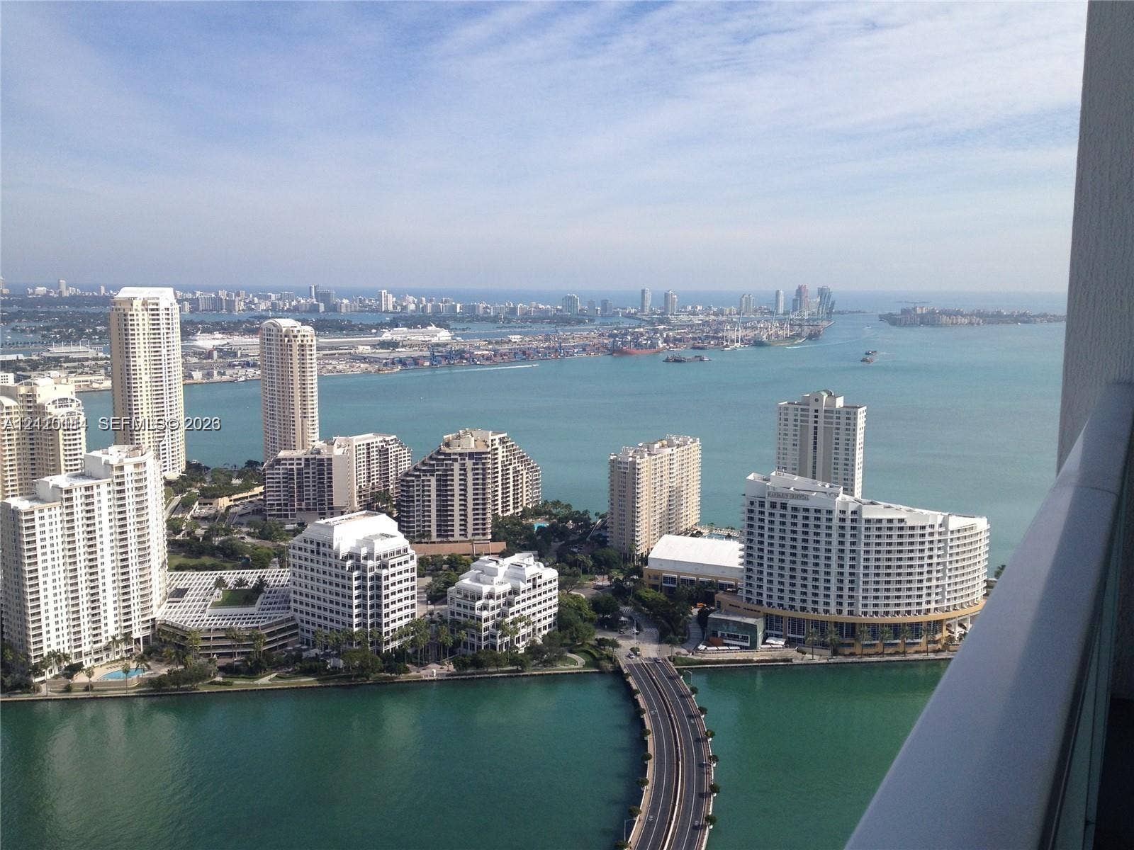 950 Brickell Bay Drive, #5108, Miami, Miami, FL 33131 Elevated balcony featuring a metal railing and a panoramic coastal and cityscape backdrop