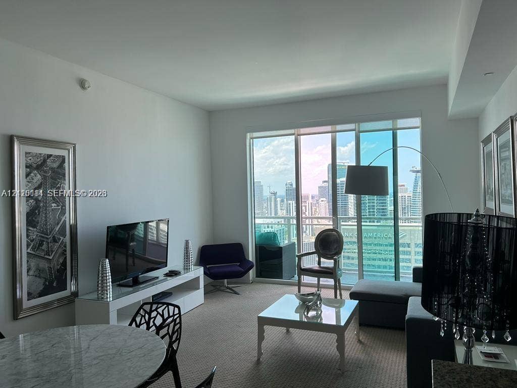 950 Brickell Bay Drive, #5108, Miami, Miami, FL 33131 Floor-to-ceiling glass windows, private balcony, and neutral carpeting