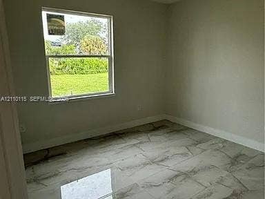 3304 11 Street W, #0, Lehigh Acres, FL 33971 Interior room featuring neutral wall paint and polished stone-finish floor tile