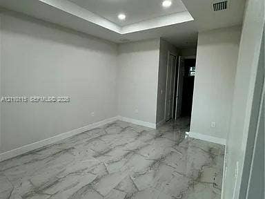 3304 11 Street W, #0, Lehigh Acres, FL 33971 Tray ceiling with recessed lighting and large-format polished tile flooring