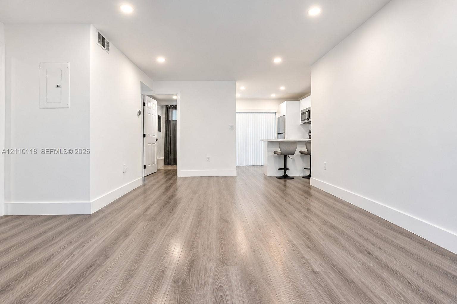 7991 SW 152nd Avenue, #701-7, Miami, Miami, FL 33193 Open interior featuring wood-finish flooring, recessed lighting, and a kitchen peninsula with integrated appliances
