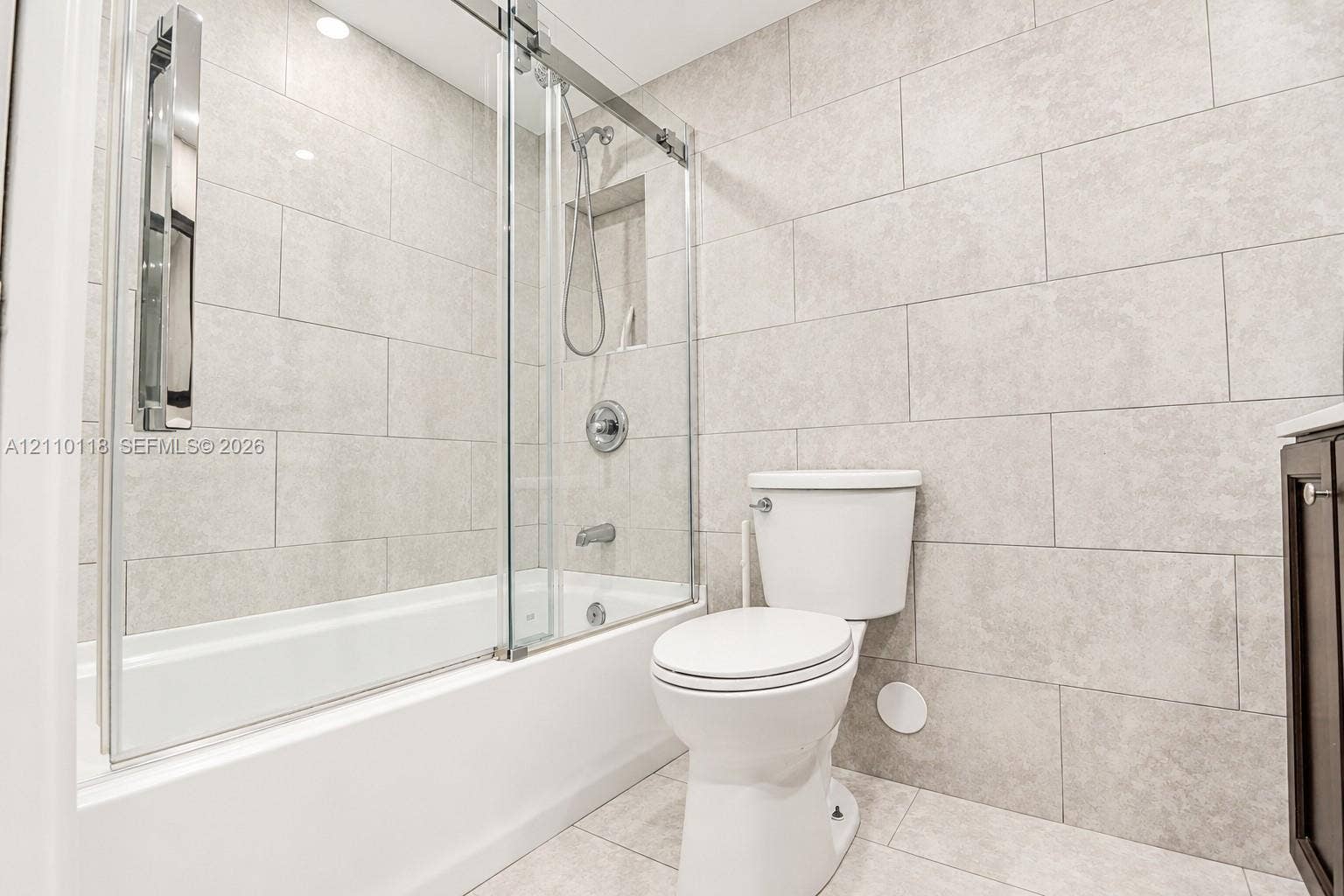 7991 SW 152nd Avenue, #701-7, Miami, Miami, FL 33193 Full-height wall tiling, glass sliding shower enclosure, recessed shower niche, tub-shower combination, and polished chrome fixtures