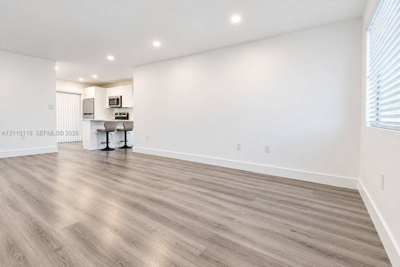 7991 SW 152nd Avenue, #701-7, Miami, Miami, FL 33193 Wood-finish flooring, recessed lighting, white cabinetry, and horizontal window blinds