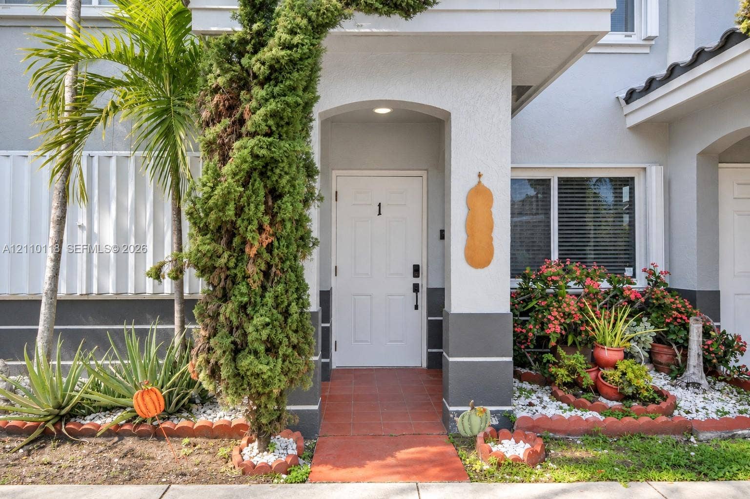 7991 SW 152nd Avenue, #701-7, Miami, Miami, FL 33193 Covered entryway with arched architectural detailing, tile flooring, and integrated overhead lighting