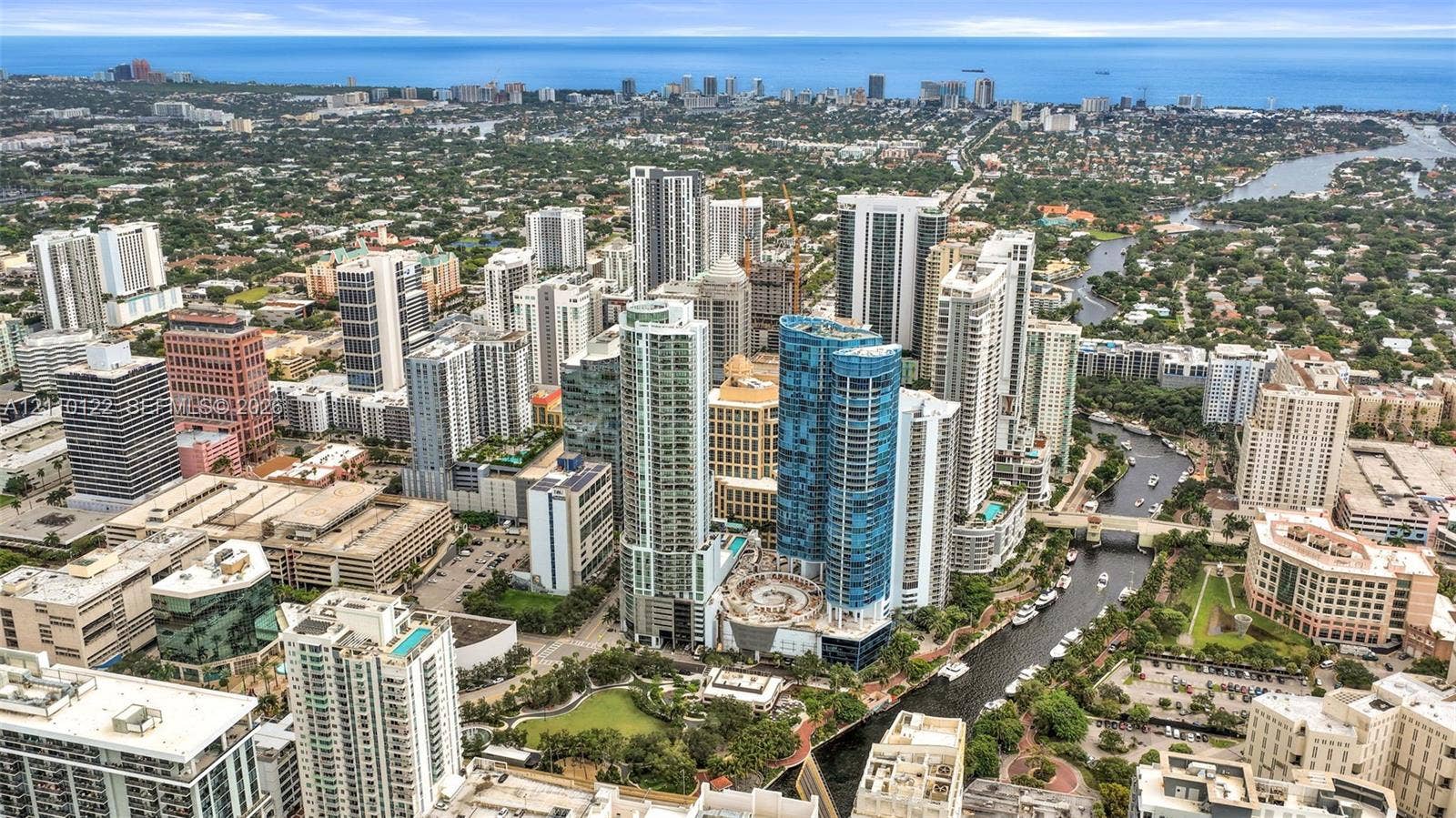 333 Las Olas Way, #2708, Fort Lauderdale, FL 33301 Aerial perspective featuring dense urban high-rise development, a central waterway, and immediate proximity to the coastline
