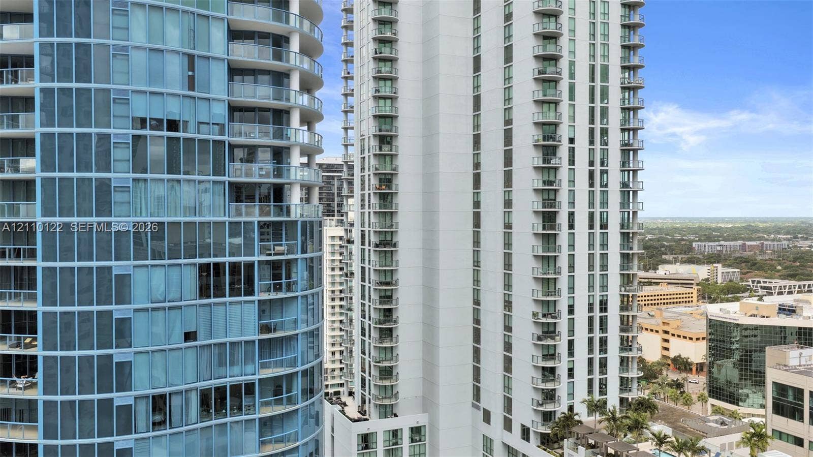 333 Las Olas Way, #2708, Fort Lauderdale, FL 33301 High-rise towers featuring blue tinted glass facades, structured steel balconies, and white architectural cladding