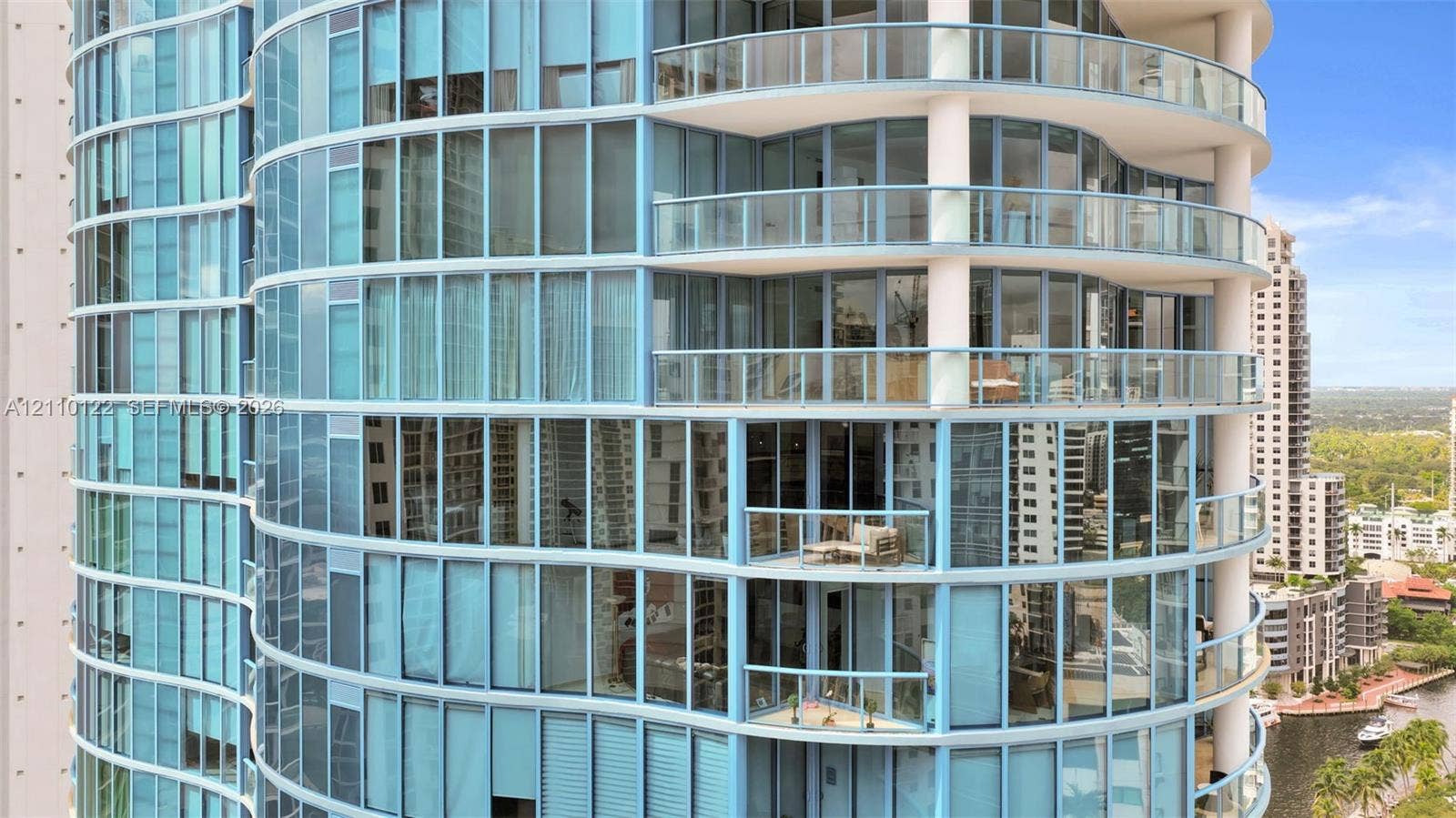 333 Las Olas Way, #2708, Fort Lauderdale, FL 33301 Curved glass facade featuring floor-to-ceiling windows, wrap-around balconies, and glass-paneled railings