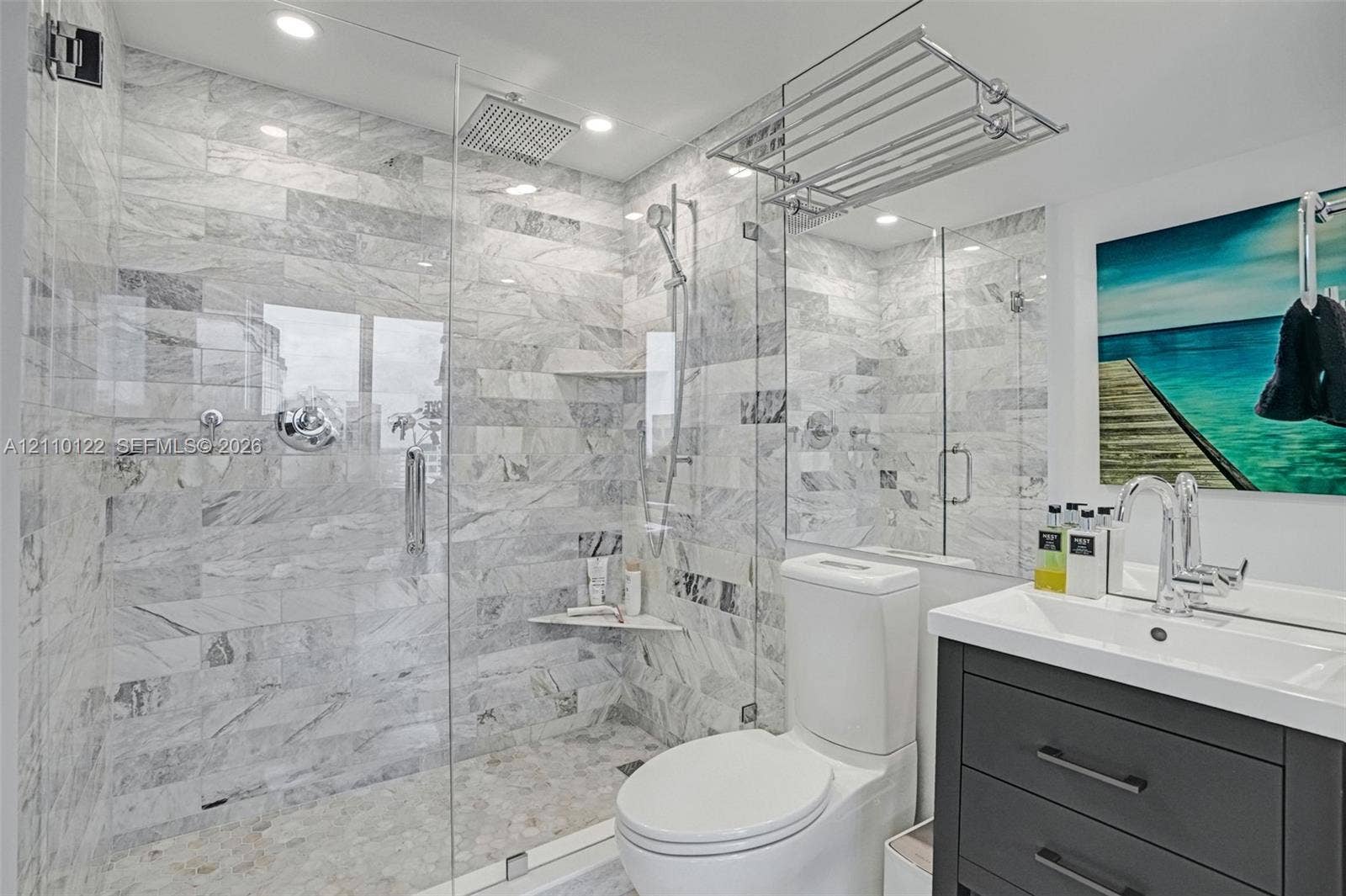 333 Las Olas Way, #2708, Fort Lauderdale, FL 33301 Walk-in shower with floor-to-ceiling stone tile, glass enclosure, rainfall shower head, handheld sprayer, and recessed shelving