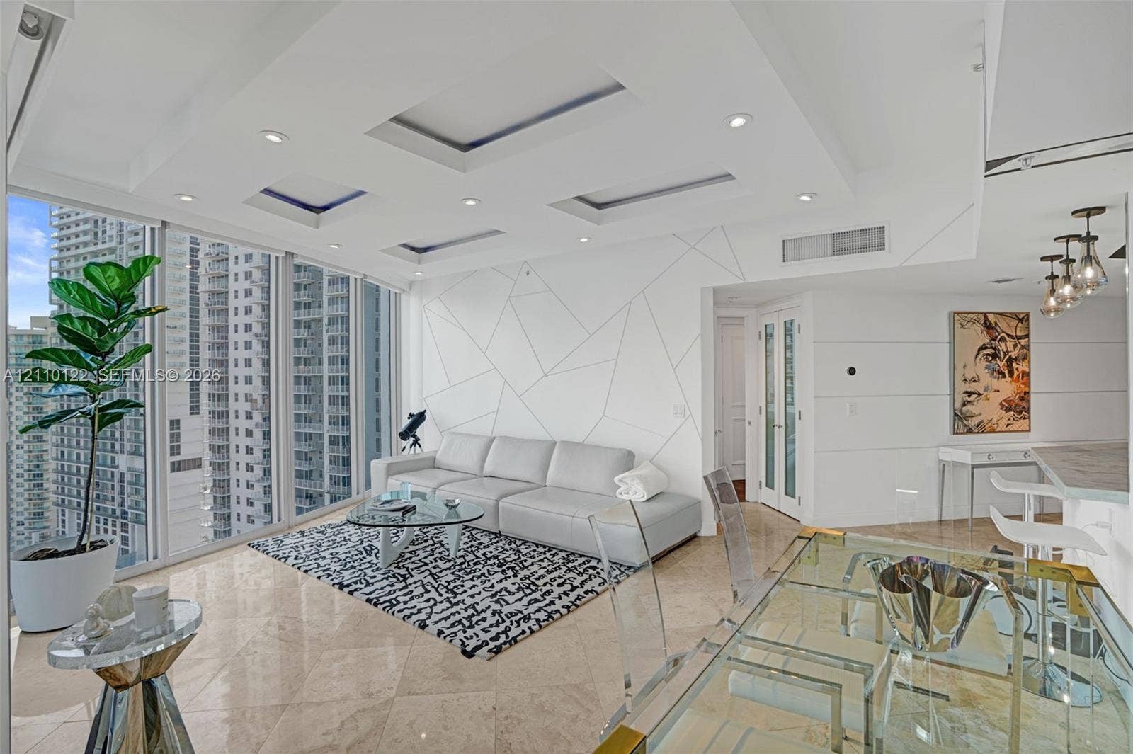 333 Las Olas Way, #2708, Fort Lauderdale, FL 33301 Open-concept living area featuring floor-to-ceiling windows, polished stone flooring, recessed tray ceiling lighting, and a custom geometric wall treatment