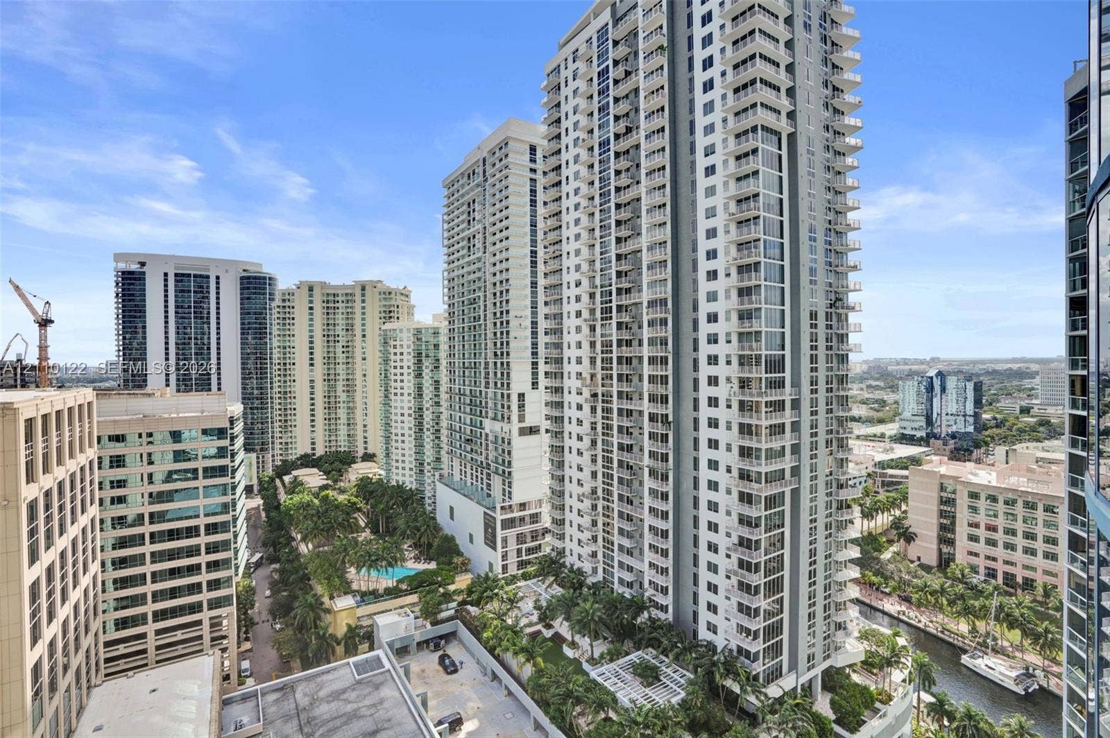 333 Las Olas Way, #2708, Fort Lauderdale, FL 33301 High-rise residential exterior featuring expansive glass facades, wrap-around balconies, and an urban landscape setting