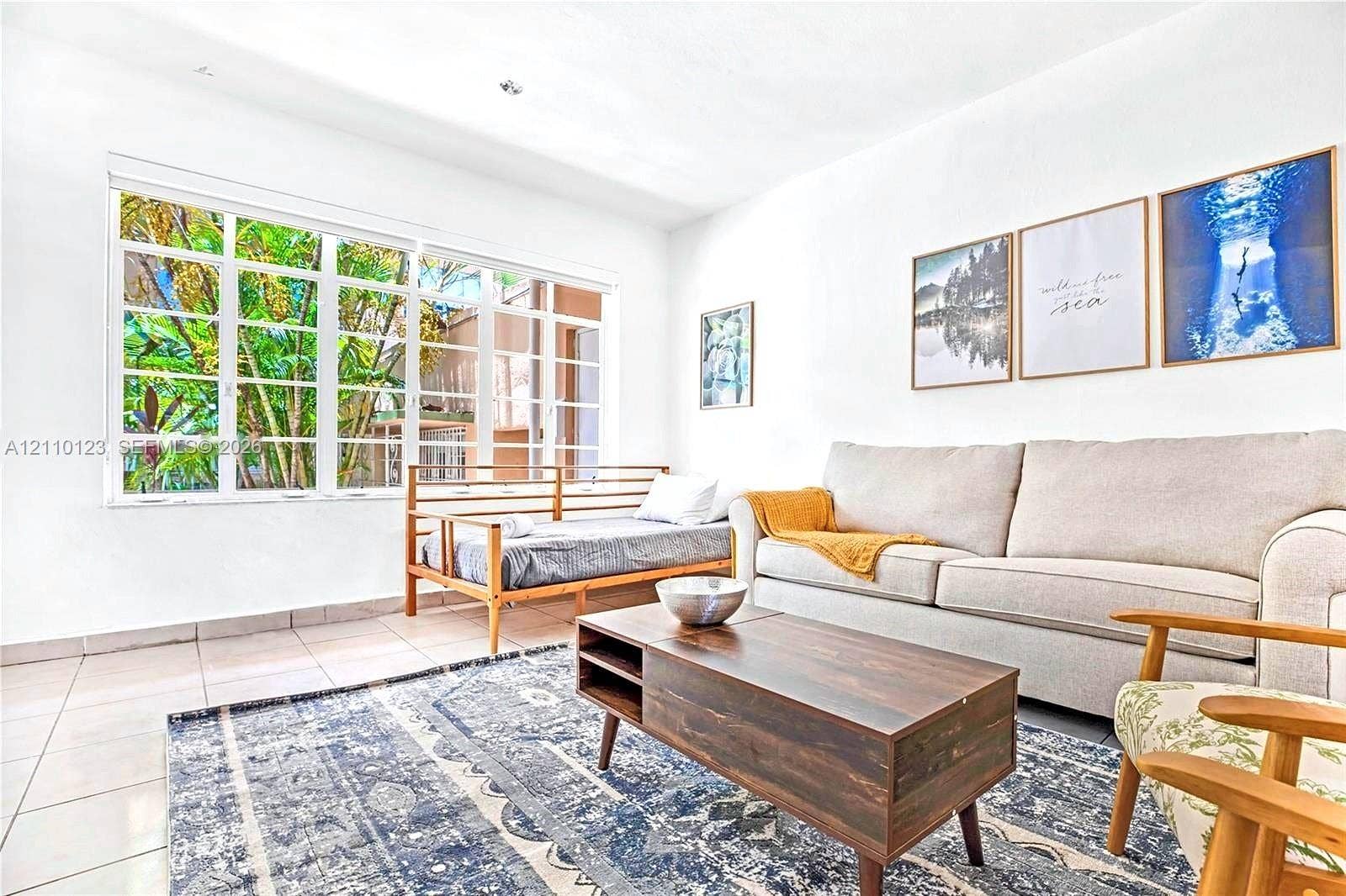 301 86th Street, #303-3, Miami Beach, Miami Beach, FL 33141 Large grid-pattern window providing abundant natural light, neutral ceramic tile flooring, and recessed ceiling lighting