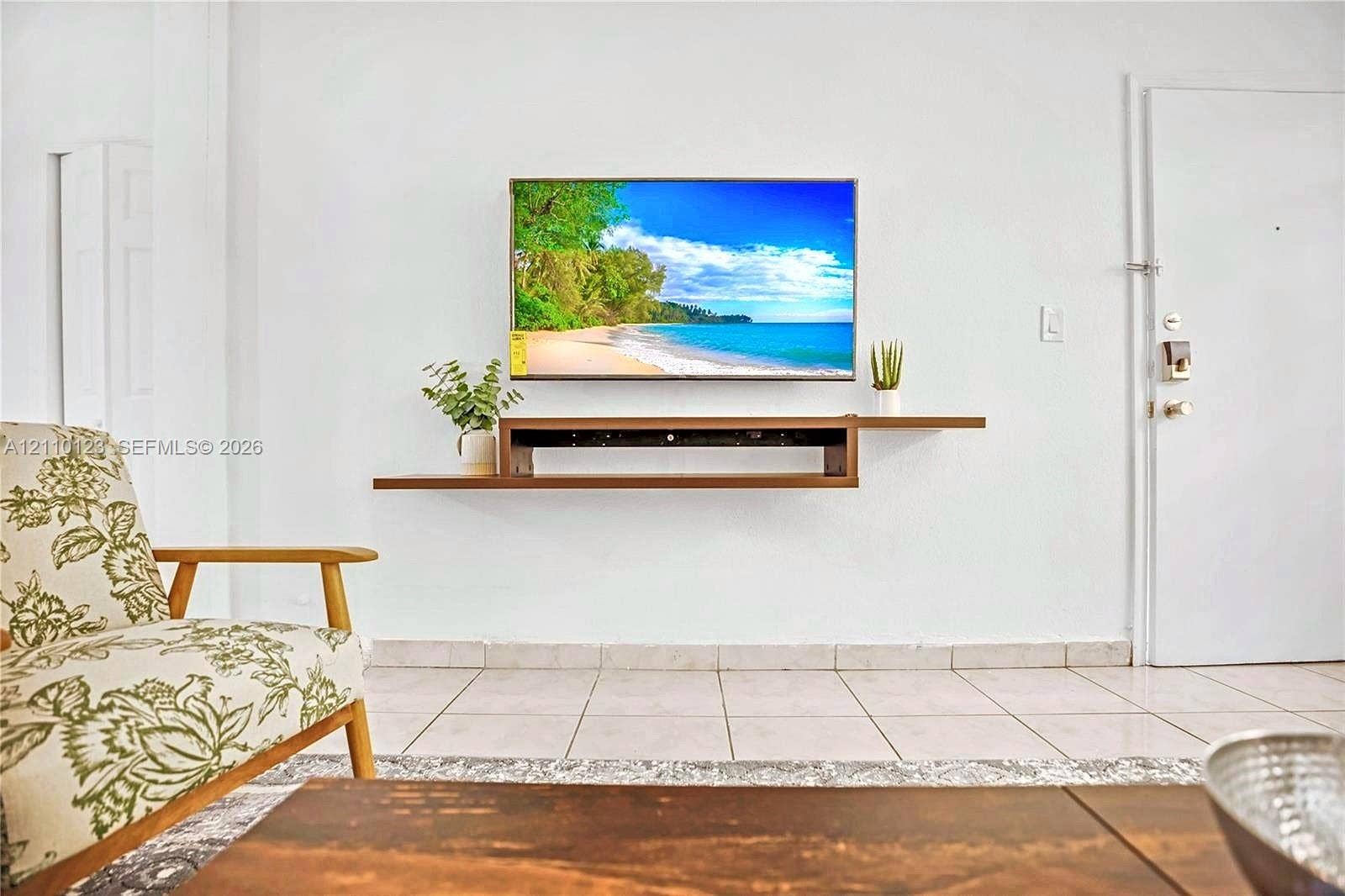 301 86th Street, #303-3, Miami Beach, Miami Beach, FL 33141 Wall-mounted wood-finish floating media console and light-colored ceramic tile flooring